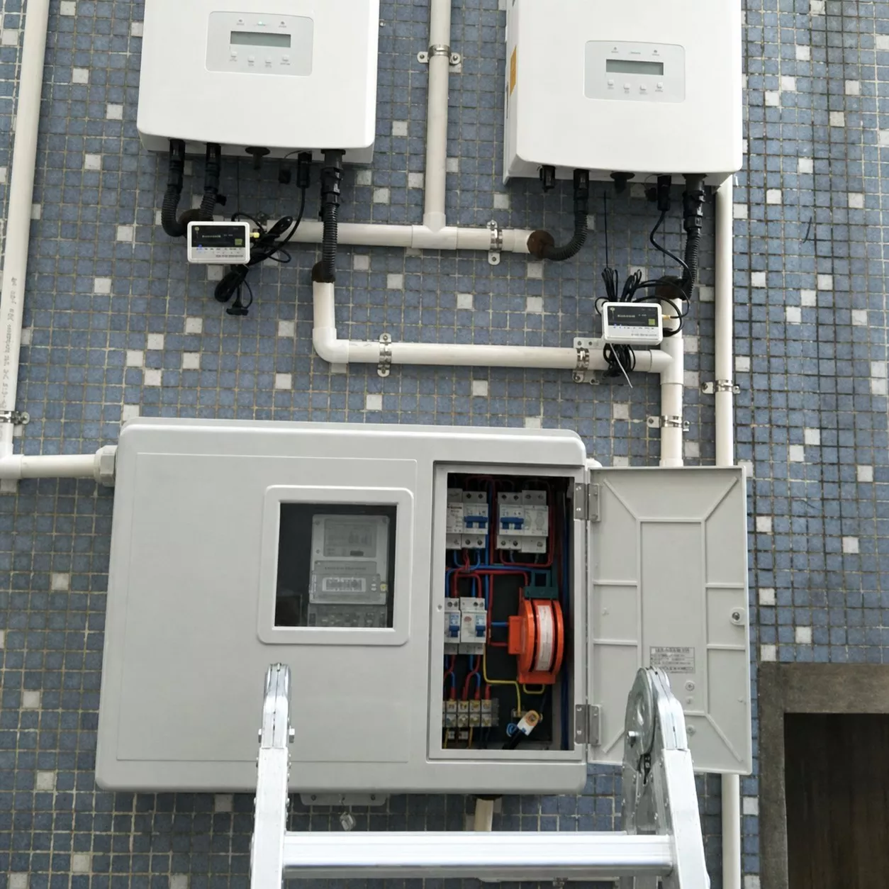 Representative rooftop solar PV installation with inverters and a distribution box housing DC surge protection