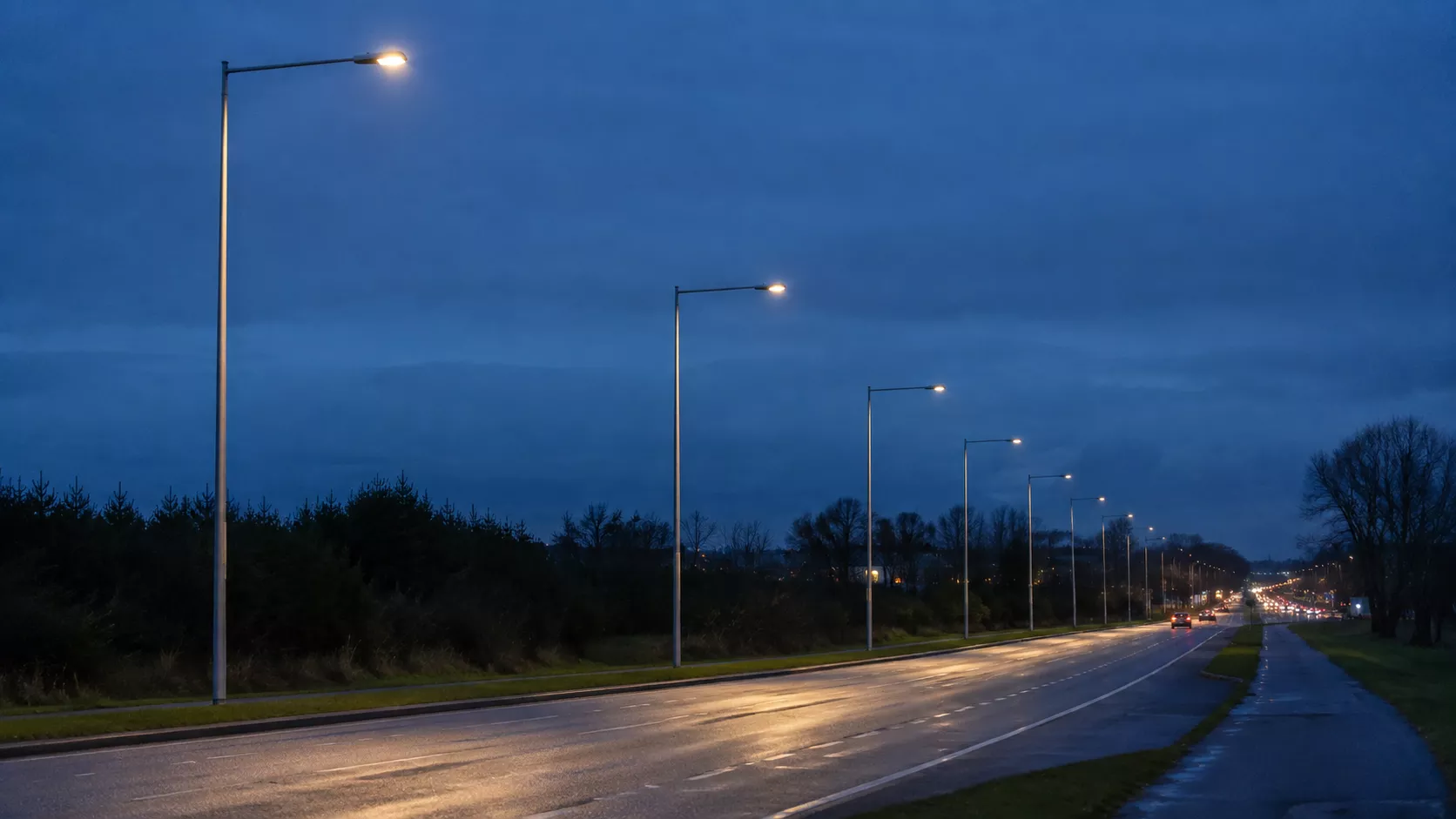 Surge protection for LED street lights on a roadway of pole-mounted luminaires at dusk
